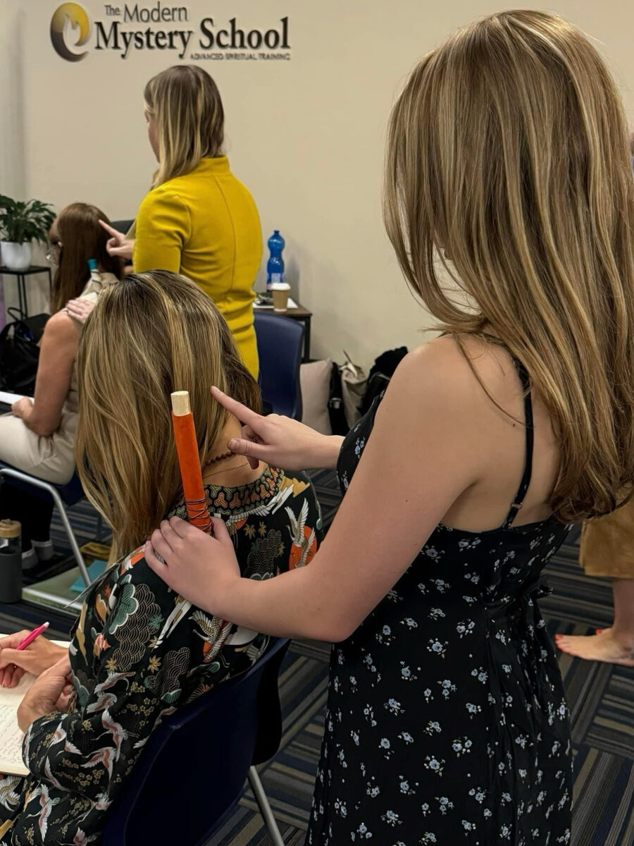 Izzy practising a healing technique during a Modern Mystery School training