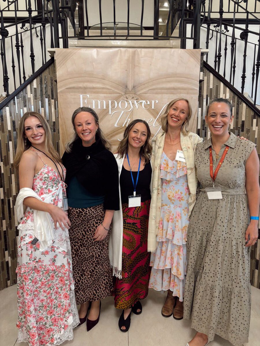 Izzy with a group of women at an Empower event